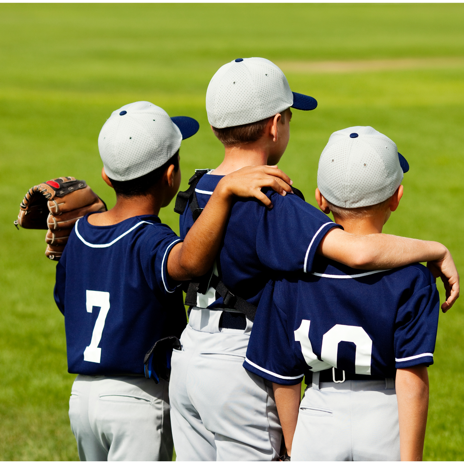 Image of 3 youth player with arms on shoulders on field